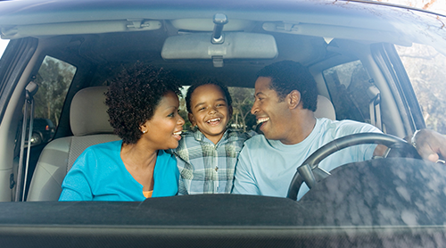 Smiling family inside the car